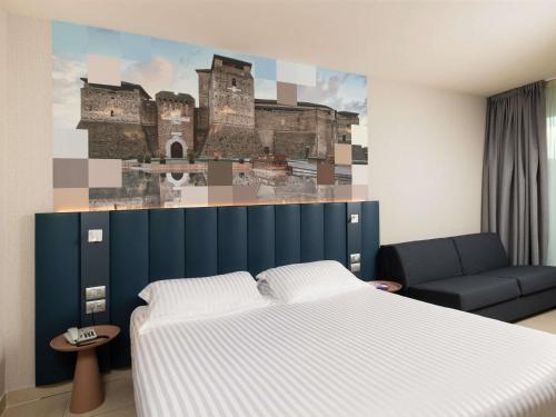 Ένα ή περισσότερα κρεβάτια σε δωμάτιο στο Mercure Hotel Rimini Artis