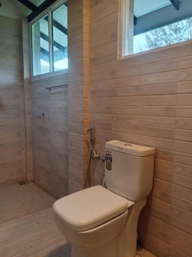 a bathroom with a toilet and a window at Mid City Apartment in Badulla