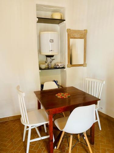 a dining room table with chairs and a coffee maker at O Ninho in Mértola