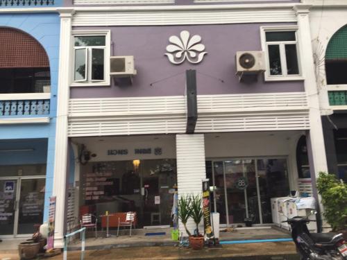 a purple building with a sign on it at Nawaporn Place in Phuket Town