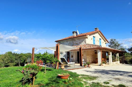 a small house in a grassy field with a sky at Villa Krug with 3 br and a pool immersed in nature near Buje in Kremenje