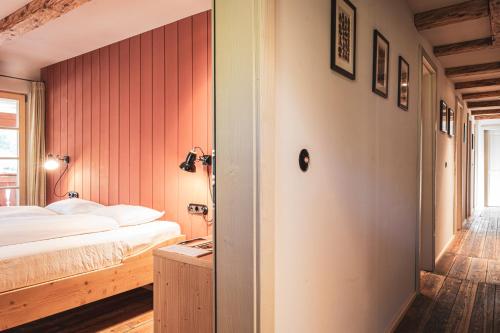a hotel room with a bed and a door at STUBN in der Frasdorfer Hütte in Frasdorf