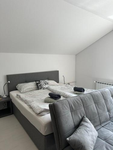 a bedroom with a large bed and a couch at Apartments and Wellness Ščavničar in Ljutomer