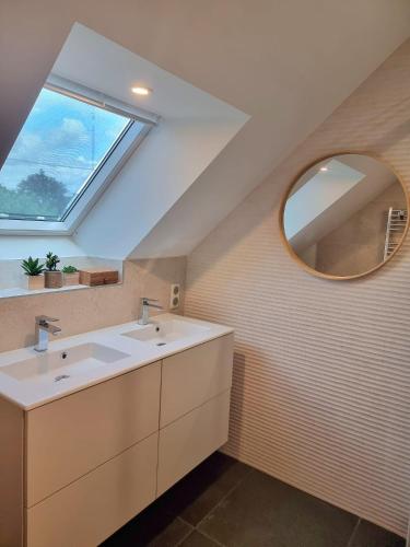 a bathroom with a sink and a mirror at La villa M Vannes, villa les pieds dans l'eau sur le port, avec grand jacuzzi in Vannes