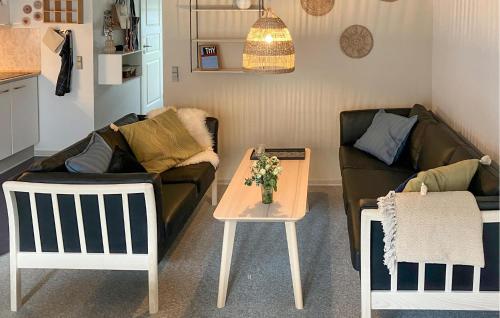 a living room with a couch and a table at Pet Friendly Home In Vestervig With Sauna in Tåbel