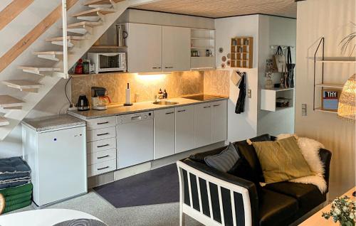 a living room with a couch and a kitchen at Pet Friendly Home In Vestervig With Sauna in Tåbel