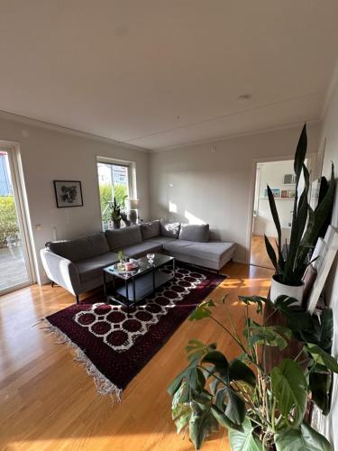 a living room with a couch and a table at Charmigt boende med egen ingång in Karlstad