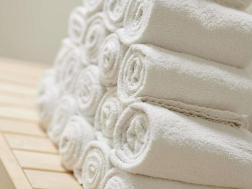 a pile of white towels sitting on a floor at ibis styles Dax Centre in Dax