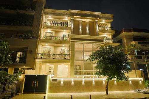 a lit up building with a tree in front of it at Millora Cyber Suites, DLF Phase 3 in Gurgaon