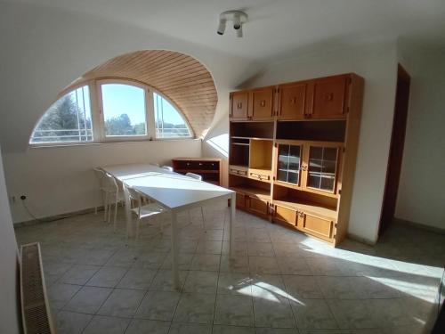 a dining room with a table and a large window at Bükfalva Bercsényi13 in Bük