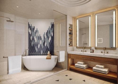 a bathroom with a large tub and a sink at The Westerly At Hilton Aruba Caribbean Resort in Palm-Eagle Beach