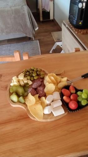 a plate of different types of food on a table at Cabana Sol Poente PR in São José dos Pinhais