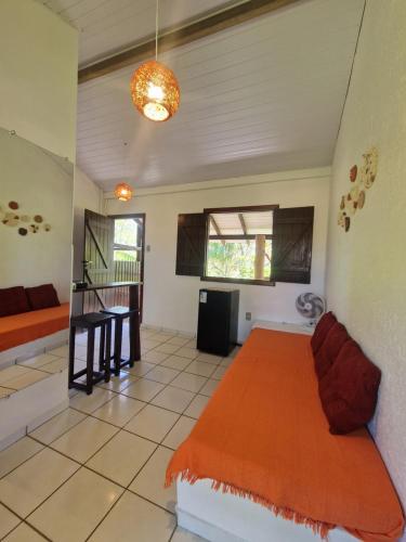 a bedroom with a bed in a room at Pousada Aconchego do Rosa - Centrinho do Rosa in Praia do Rosa