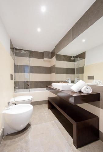a bathroom with a toilet and a sink at Martinhal Lisbon Chiado in Lisbon