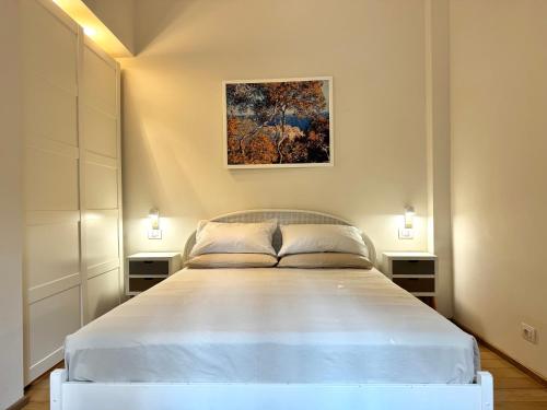 a bedroom with a large white bed in a room at Villa Angelina Holiday Homes I Casa UG I Antica Villa I Giardino I 4 ospiti I Mare 5 min I Parcheggio privato in Vallecrosia