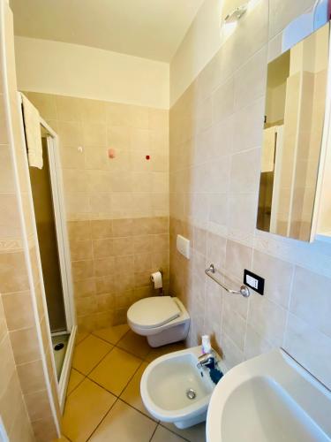 a bathroom with a white toilet and a sink at Casa Giuliana in Teglio