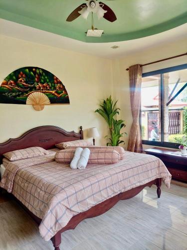 a bedroom with a bed and a ceiling fan at Leelawadee House - 3 bedroom private villa with pool in Nathon Bay