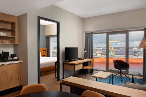 a hotel room with a bed and a view of a city at Residence Inn by Marriott Amsterdam Houthavens in Amsterdam