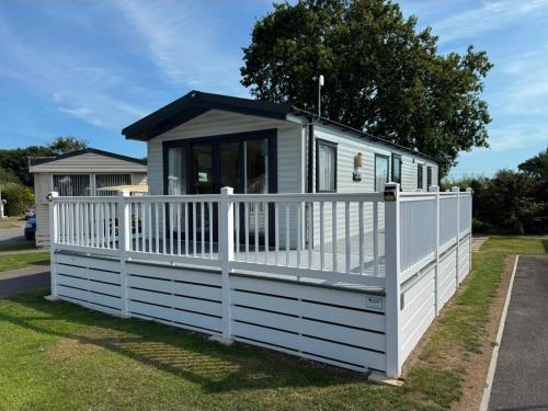 a tiny house with a white fence at 13 West Drive in Warsash