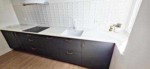 a kitchen with a sink and a counter top at Sand House Gorliz By Kima Gestión in Górliz-Elexalde