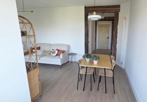 a living room with a table and a couch at Sand House Gorliz By Kima Gestión in Górliz-Elexalde