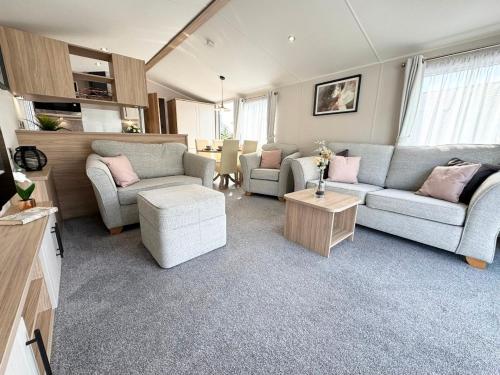 a living room with two couches and a table at 13 West Drive in Warsash