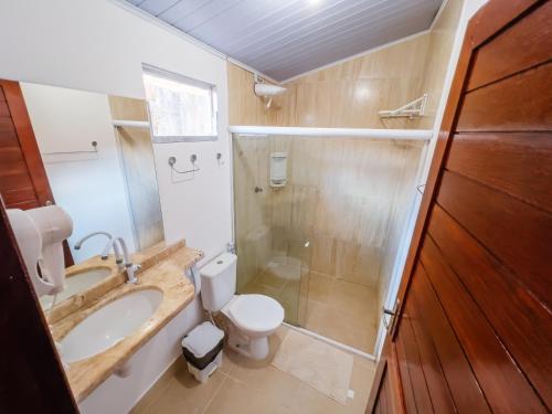 a bathroom with a toilet and a sink and a shower at Pousada do Enildo in São Miguel dos Milagres