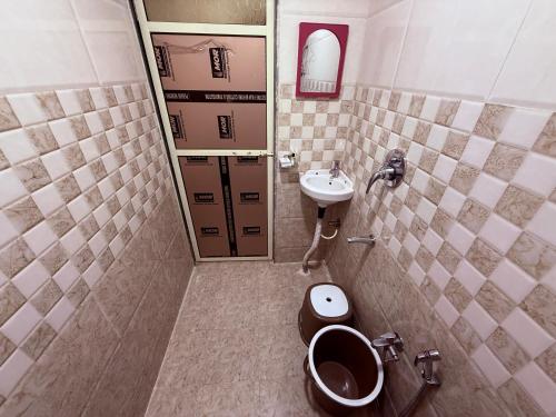 a small bathroom with a toilet and a sink at Riverside Retreat Dombivli in Dombivli