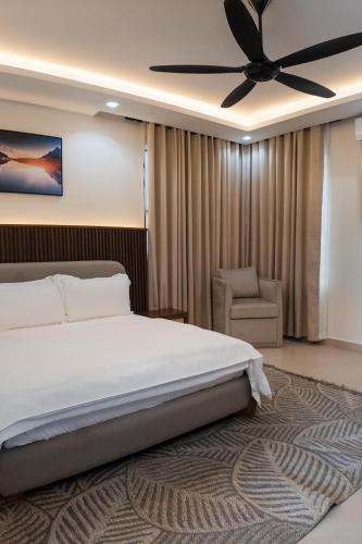 a bedroom with a bed and a ceiling fan at Marafiki Villa in Dar es Salaam