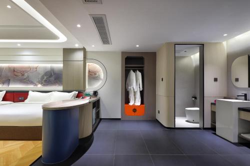 a hotel room with a bed and a bathroom at Lucky house in Gaotian