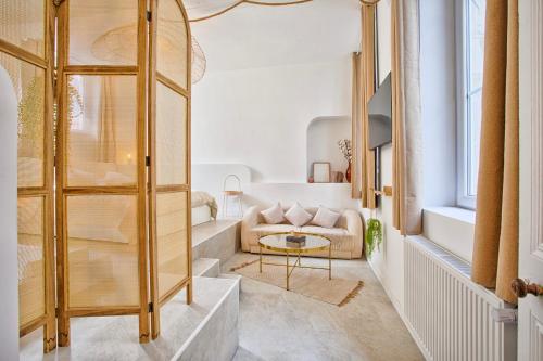 a living room with a couch and a table at Le Saint-Sauveur - Balneotherapy Bathtub - Hypercentre in Caen