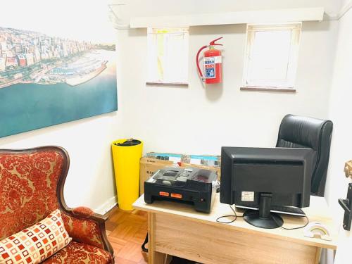 a room with a desk with a computer and a chair at Tranquility Homes in Durban