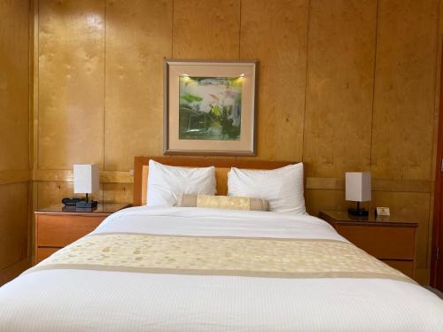 a bedroom with a large white bed with two lamps at The Eldon Luxury Suites in Washington