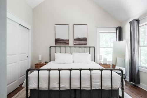 a bedroom with a bed with white sheets at The Cove Retreat- Hot Tub/Screened Porch/Game Room in Lake Lure