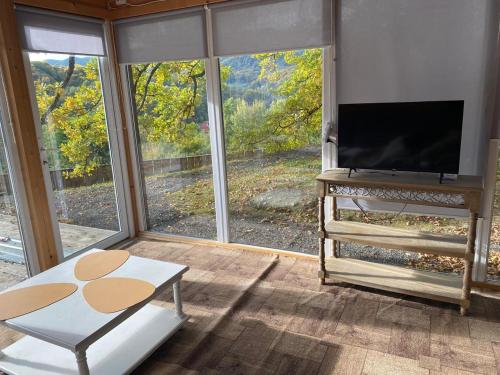 a living room with a flat screen tv and a couch at Панорама Шаян in Shaian