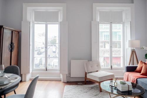 a living room with a couch and a table at Stylish Flat in the heart of South Kensington in London