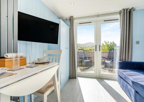 a living room with a table with a tv and a couch at South View Retreat in Carlton