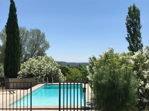 Le cabanon في Vaugines: مسبح في حديقة بها أشجار