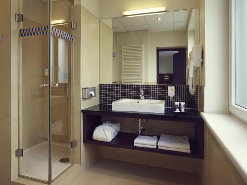 a bathroom with a sink and a shower at Mercure Warszawa Airport in Warsaw