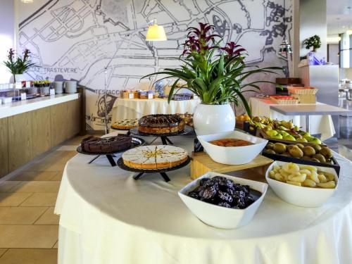 a buffet of food on a table in a restaurant at Ibis Styles Roma Eur in Rome