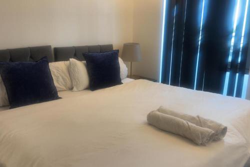 een groot wit bed met een handdoek erop bij London 1 Bed Apartment close to Barking Station in Barking