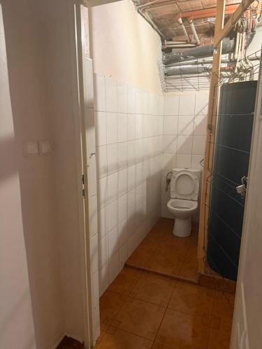 a bathroom with a toilet in a room at SultanHostel in Warsaw
