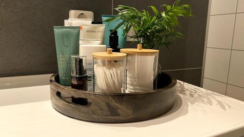 a container filled with toiletries on a counter in a bathroom at Sjelefred - Ocean Suite in Sortland