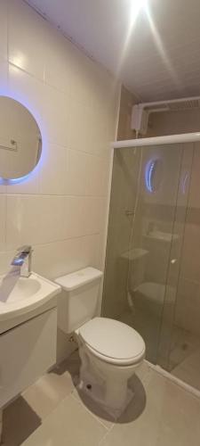 a bathroom with a shower and a toilet and a sink at Arvore da Vida Pousada in Itaguaí