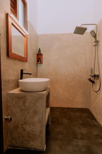 a bathroom with a sink and a shower at Amarante Madiha in Matara