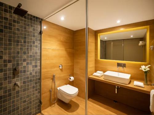 a bathroom with a toilet and a sink and a shower at Hotel Hilltop Palace in Udaipur