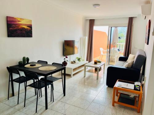 a living room with a table and chairs and a couch at Cielo Dorado in Santiago del Teide