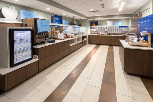 an apple store with a large screen in the middle at Holiday Inn Express & Suites - Commerce by IHG in Commerce