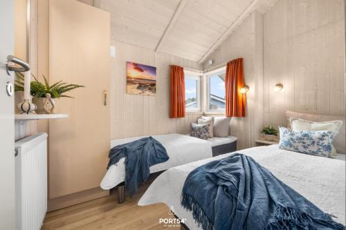 Ένα ή περισσότερα κρεβάτια σε δωμάτιο στο Ferienhaus Möwenstübchen Grömitz