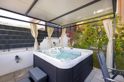 a bath tub in the middle of a yard at HIDDEN PARADISE - Villa by Split in Žrnovnica